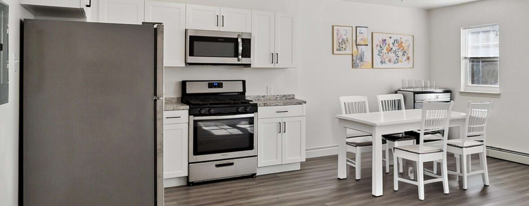 a kitchen with white cabinets